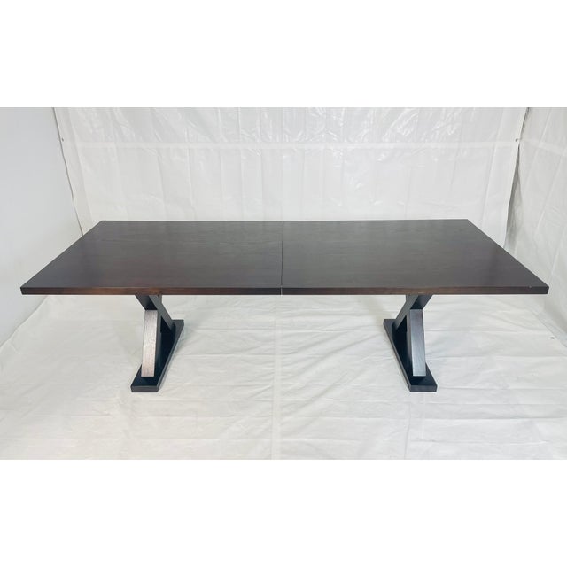 An architecturally refined “Courier” dining table designed by Christian Liaigre for Holly Hunt, executed in solid oak wood...