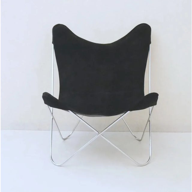 Butterfly style chair in black suede and chromed steel structure. Made in Italy in the 1960s