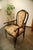 This antique carver armchair dates from approximately 1890–1920 and features a Queen Anne Revival design with Chippendale...