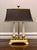 The most charming petite, hand-finished brass twin candelabra bouillotte style library desk lamp by Wildwood. It features...