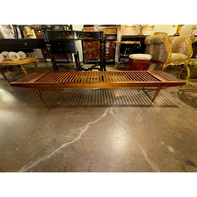 This vintage Milo Baughman Walnut Spindle Bench for Glen of California is a beautifully crafted piece of furniture...