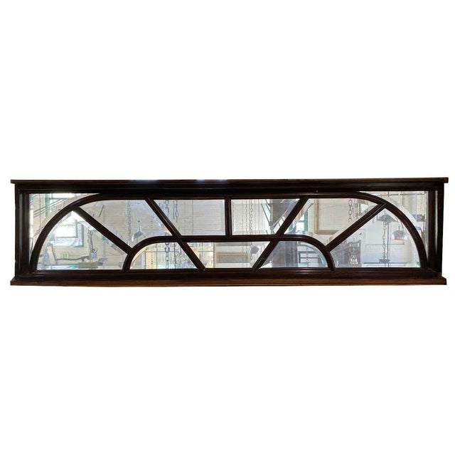 DETAILS A vintage, rectangular door transom window fashioned with beveled panes set into the solid mahogany frame with...