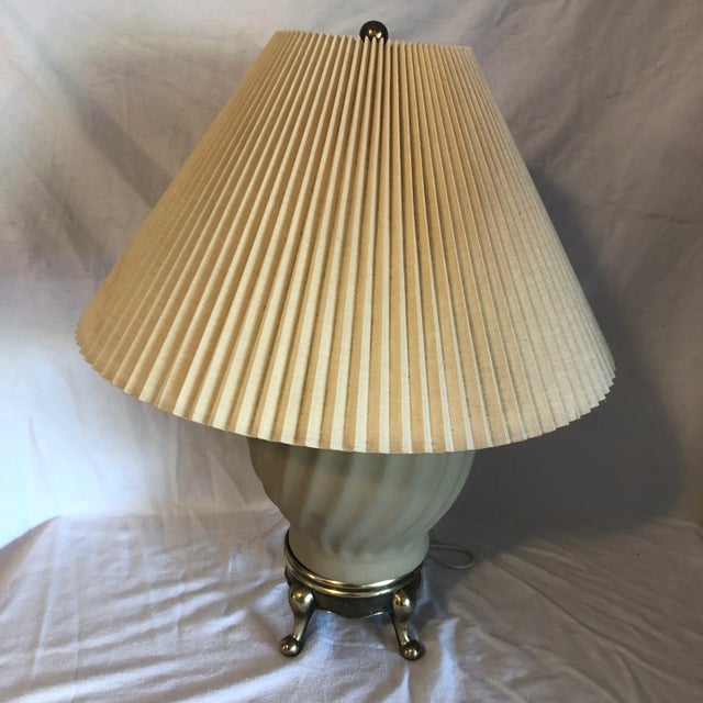 Sage green ceramic swirl design on a four footed brass.