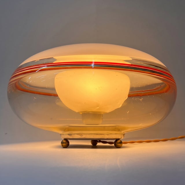 A refined and elegant pair of lenticular/disc-shaped table lamps, produced in Italy in the 1970s and attributed to the...