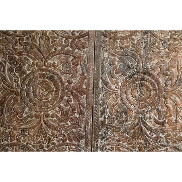 An exquisite pair of vintage hand-carved wooden doors featuring a central lotus medallion motif, symbolizing harmony and...
