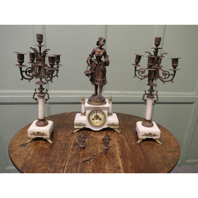 19th Century French Signed Bronze Clock and Garniture. A 19th Century French bronze mantle clock and candelabra garniture....
