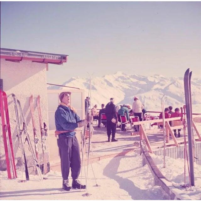 Mountain Top 1951 A skier checks their skis at a mountain top terrace, Klosters, Switzerland, 1951. Toni Frissell...