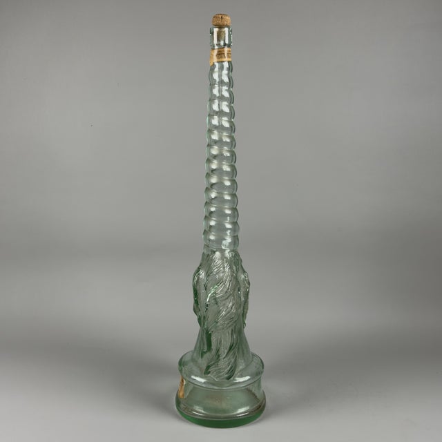 A spectacular and rare figurative bottle of exceptional size (over 70 cm tall), a truly iconic piece of Italian glass...