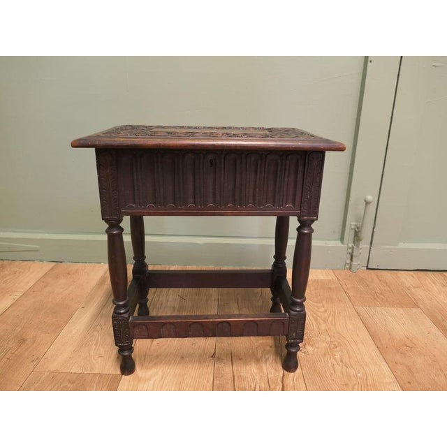 This is a beautifully carved Oak Joint Stool with a linen fold design around the sides and twining leaves on the top, it...