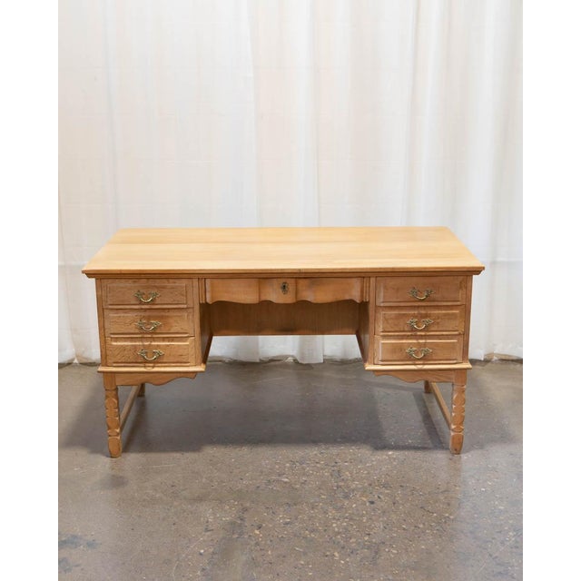 A substantial Danish oak writing desk attributed to Henning Kjærnulf, produced in the 1970s and bringing together the...