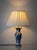 A Royal Delft vase, hand-painted in the Netherlands and mounted as a table lamp, its body carrying a long-tailed bird...