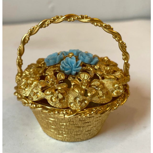Love this beautiful gold metal trinket box with blue flowers on top.