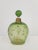 Beautiful and elegant bottle with stopper by Daum, Nancy. France late 19th century. Light green with flowers in relief all...