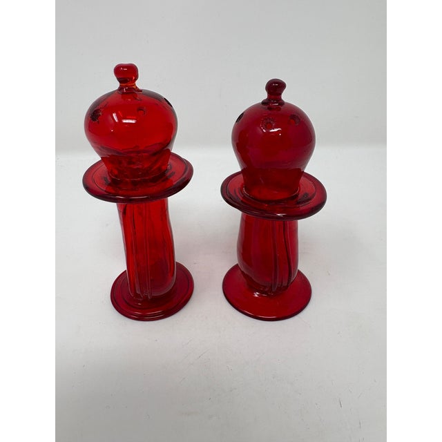Cute pair of Ruby Red salt and pepper shakers from Murano, Italy. Measure 4" tall.