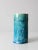 A striking vintage studio pottery vase, hand-crafted in a tall, elegant form and finished in a vibrant sea-blue glaze....