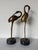 Striking vintage pair of life-size brass crane sculptures featuring elegant elongated necks, finely detailed beaks, and...
