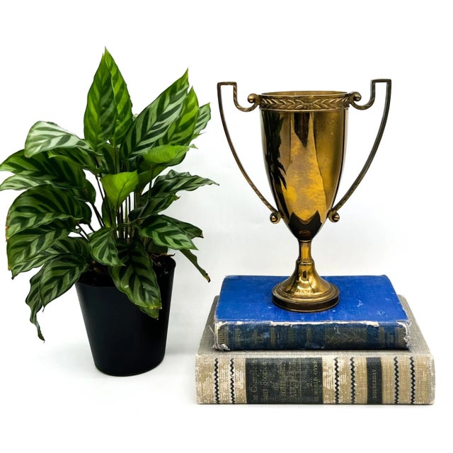 Stately vintage brass trophy cup by Arlen Trophy Co. of Brooklyn, New York, featuring a classic urn silhouette with...