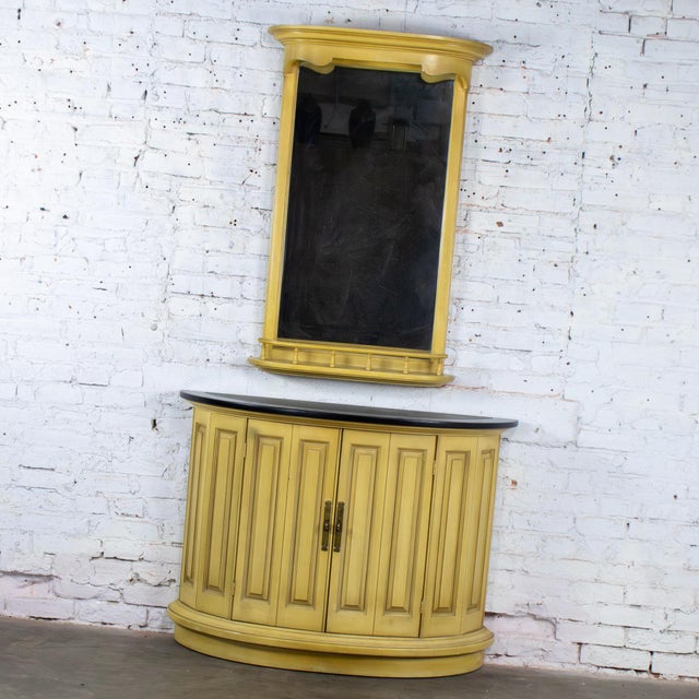 Handsome vintage Neoclassic Revival demilune cabinet or console and wall mirror both composed of blonde oak frames while...
