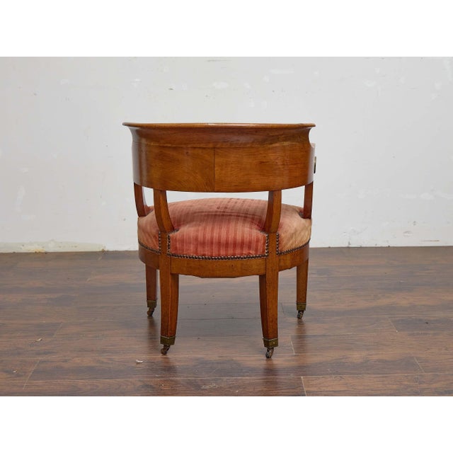 This 19th-century Biedermeier tub chair has the quiet, confident presence that walnut furniture from this period does so...