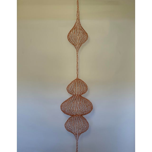 A striking monumental handwoven copper wire hanging sculpture in the style of Ruth Asawa, showcasing the delicate...