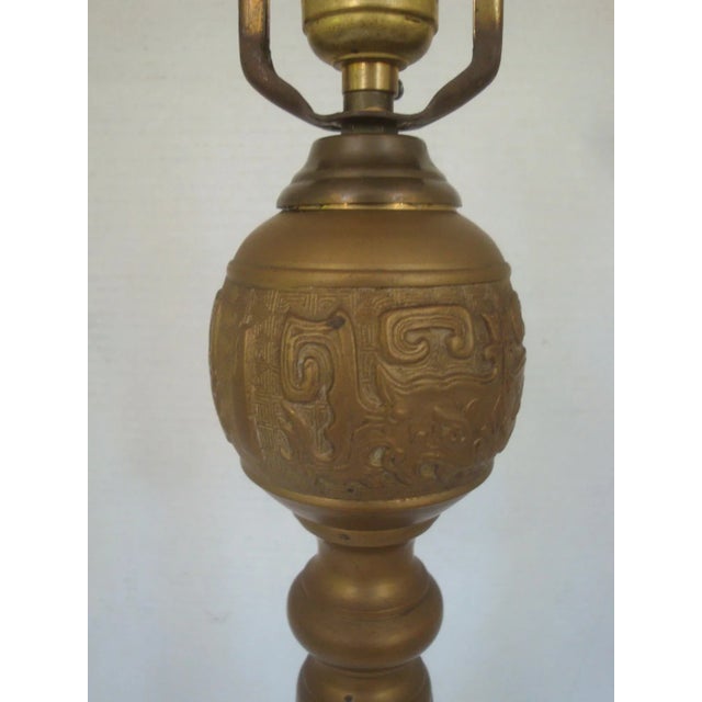 Tall and sculptural hefty brass candlestick form table or buffet lamp in the manner of famed designer James Mont...