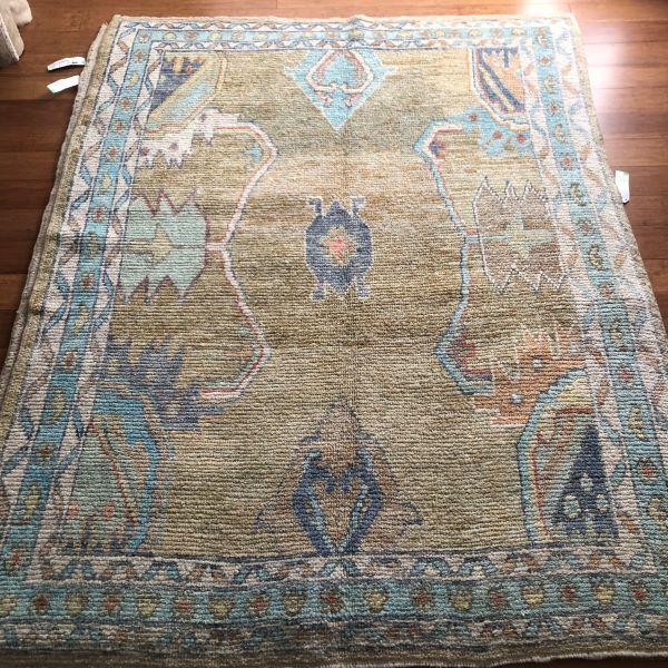 This contemporary Turkish Oushak rug is defined by its asymmetrical geometric composition and a palette that balances...