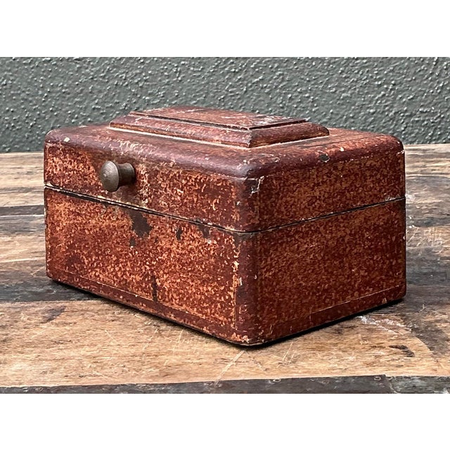 This antique lidded box offers a soulful blend of rustic charm and timeless utility, perfect for the collector who...