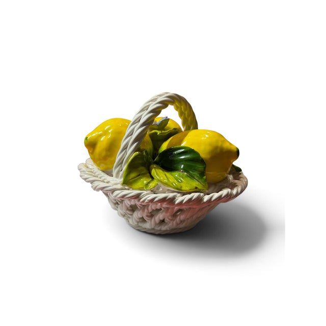 Charming Italian ceramic centerpiece featuring a sculptural arrangement of bright yellow lemons, richly glazed green...