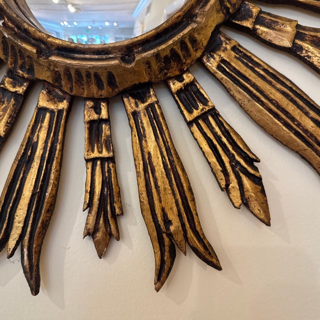 This striking Antique Sunburst Mirror, c. 1940, is a timeless statement piece that channels the glamour and artistry of...