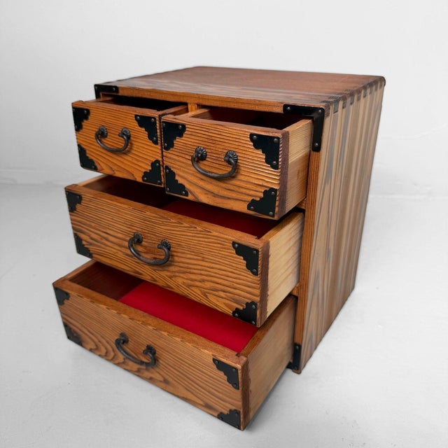 An elegant small jewellery cabinet made from sugi wood, Japanese cedar, with a warm wood tone, pronounced grain pattern,...
