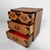 An elegant small jewellery cabinet made from sugi wood, Japanese cedar, with a warm wood tone, pronounced grain pattern,...