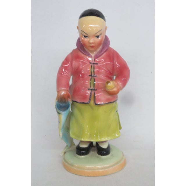 This amazing Asian Boy with Fish Figurine is made out of ceramic. This lovely piece was designed by art potter Brad Keeler...