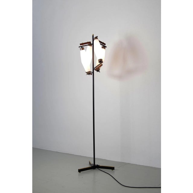 - Floor lamp made in Italy, 1960s - With four opaline glass shades - A painted metal stem with teak and brass accents...