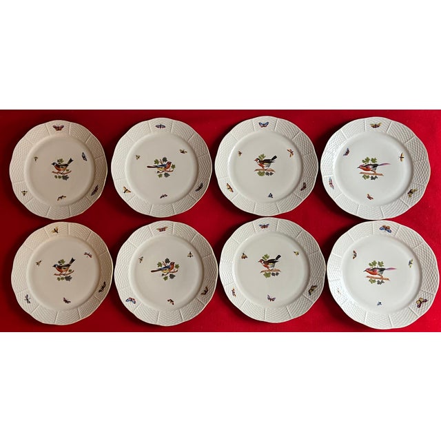 Set of 8 Herend porcelain dinner plates decorated with birds, butterflies and insects with basketweave rim. Measure 10"...