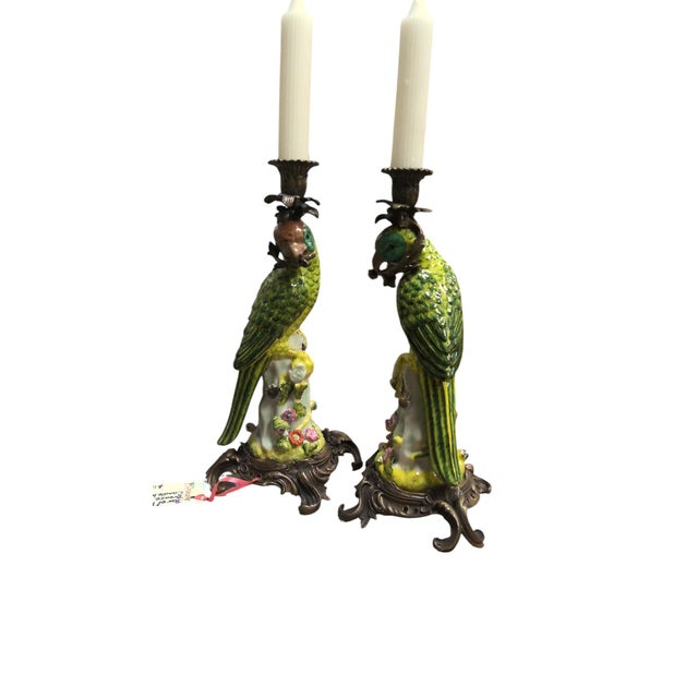 Gorgeous pair of brass mounted porcelain parrot candlestick holders. Ornately decorated porcelain base delicately painted...