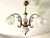 Three-light chandelier from the 1970s in the Art Nouveau style, gilt brass and white porcelain frame, three frosted white...