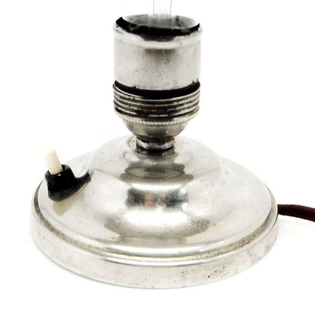 The desk lamp is from the 50s. It is a cabinet lamp in the modernist style. Preserved in very good condition. The holder...