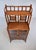An impressive faux bamboo British Colonial style etagere cabinet featuring two mirrors, fixed interior shelves and glass...