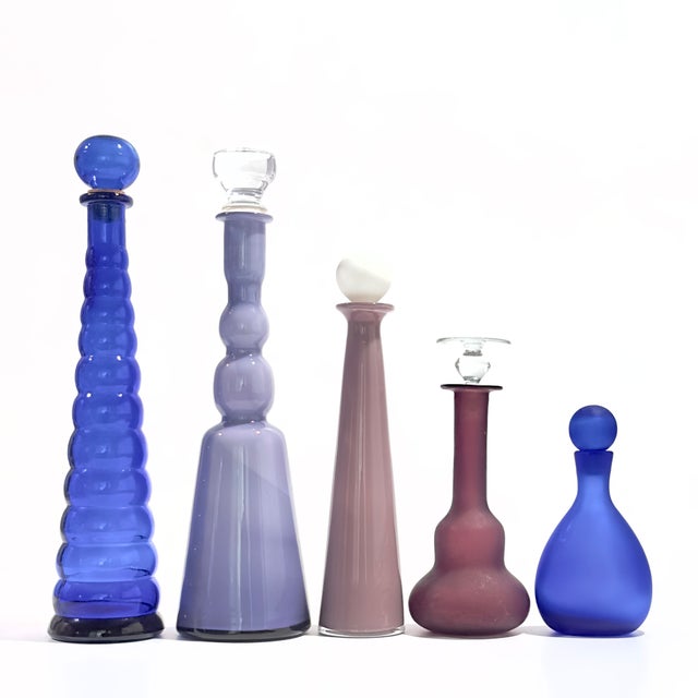 Elevate your interior styling with this breathtaking curation of mid-century and contemporary art glass decanters....