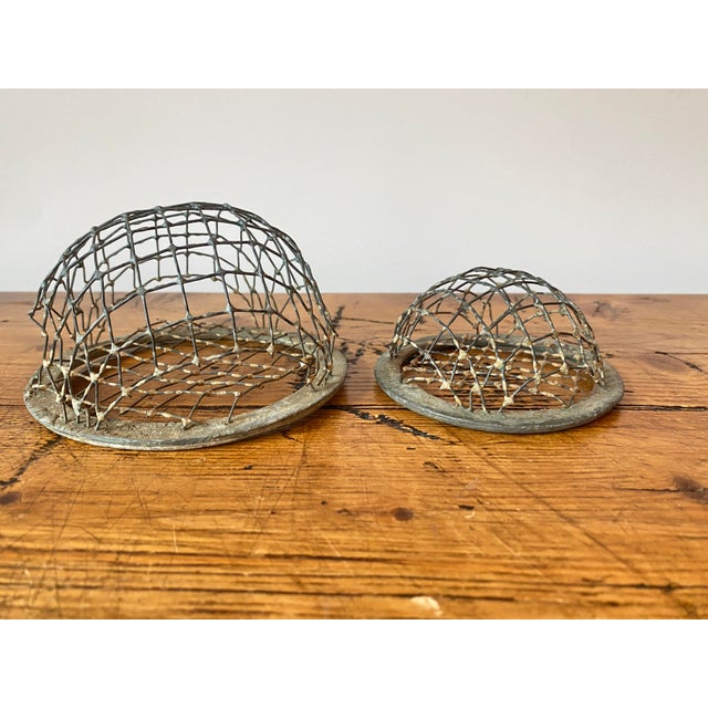 Really beautiful pair of lead cage style flower frogs. They are both marked, as best as I can tell, with the letters PAT-...