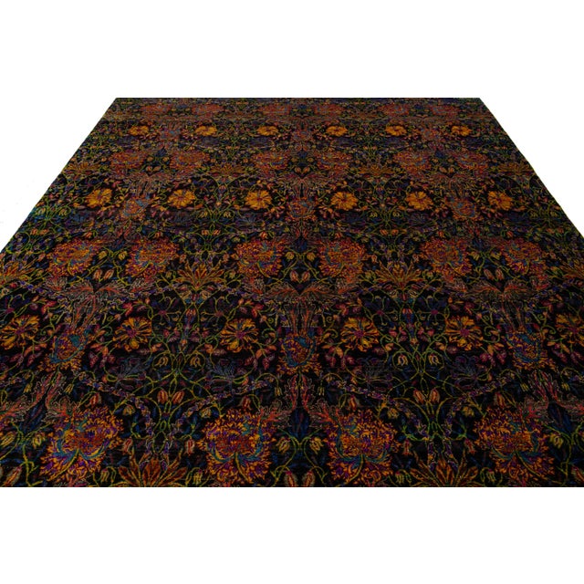 This stunning hand-knotted rug showcases a captivating abstract design in vibrant colors that effortlessly captures...