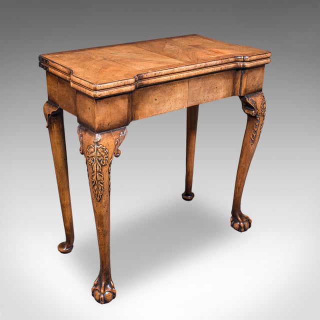 This is an antique fold-over bridge table. An English, golden walnut game or card table, dating to the Georgian period,...
