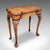 This is an antique fold-over bridge table. An English, golden walnut game or card table, dating to the Georgian period,...