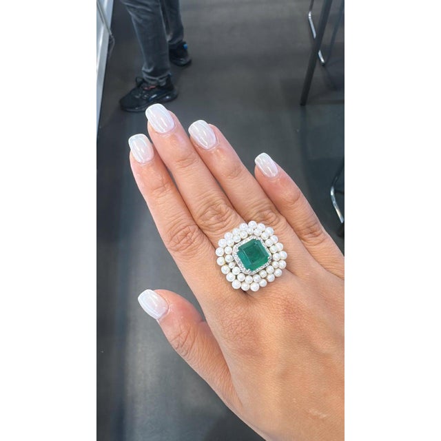 A very gorgeous and beautiful, modern style, Emerald Cocktail Ring set in 18K White Gold & natural Diamonds. The weight of...