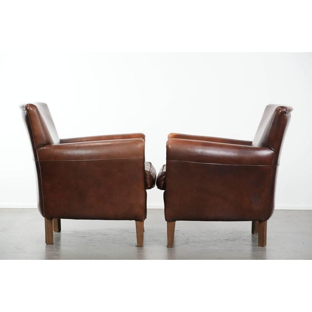 We are offering this elegant set of two distinctive vintage sheepskin armchairs in beautiful warm colors. This set of two...