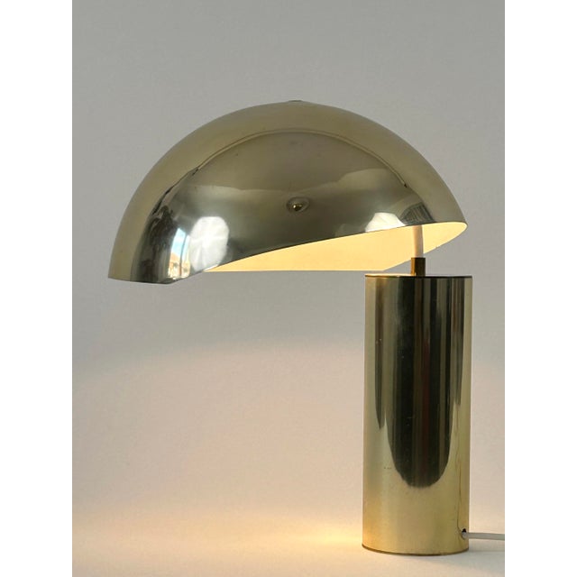 Extremely rare and elegant mid-century modern table lamp with an asymmetrical lamp shade. Designed and manufactured by...