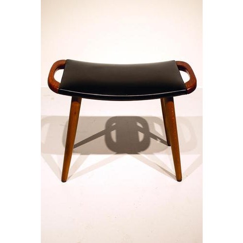 Scandinavian stool or hocker made of teak with leatherette upholstery. In good vintage condition. Measurements H. 38 cm;...