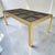 Vintage brass and bronze tinted glass panel parsons dining table by Mastercraft. Manufactured in the 1980s this epic...