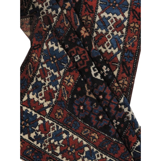 From N.W. Persia a lovely antique hand knotted wool runner. Colors navy/multi.