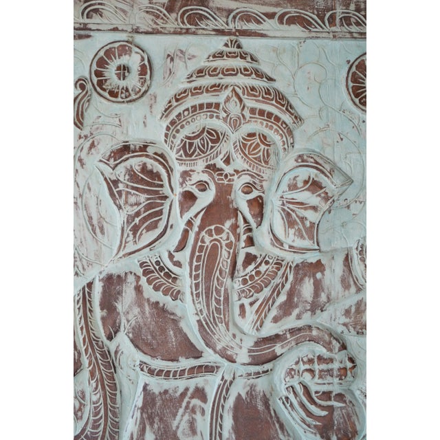 Bring divine charm and positive energy into your home with this hand-carved wooden Ganesha wall sculpture. Crafted with...
